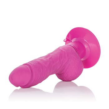 Shower Stud Super Stud Vibe laying on table head of dildo facing camera