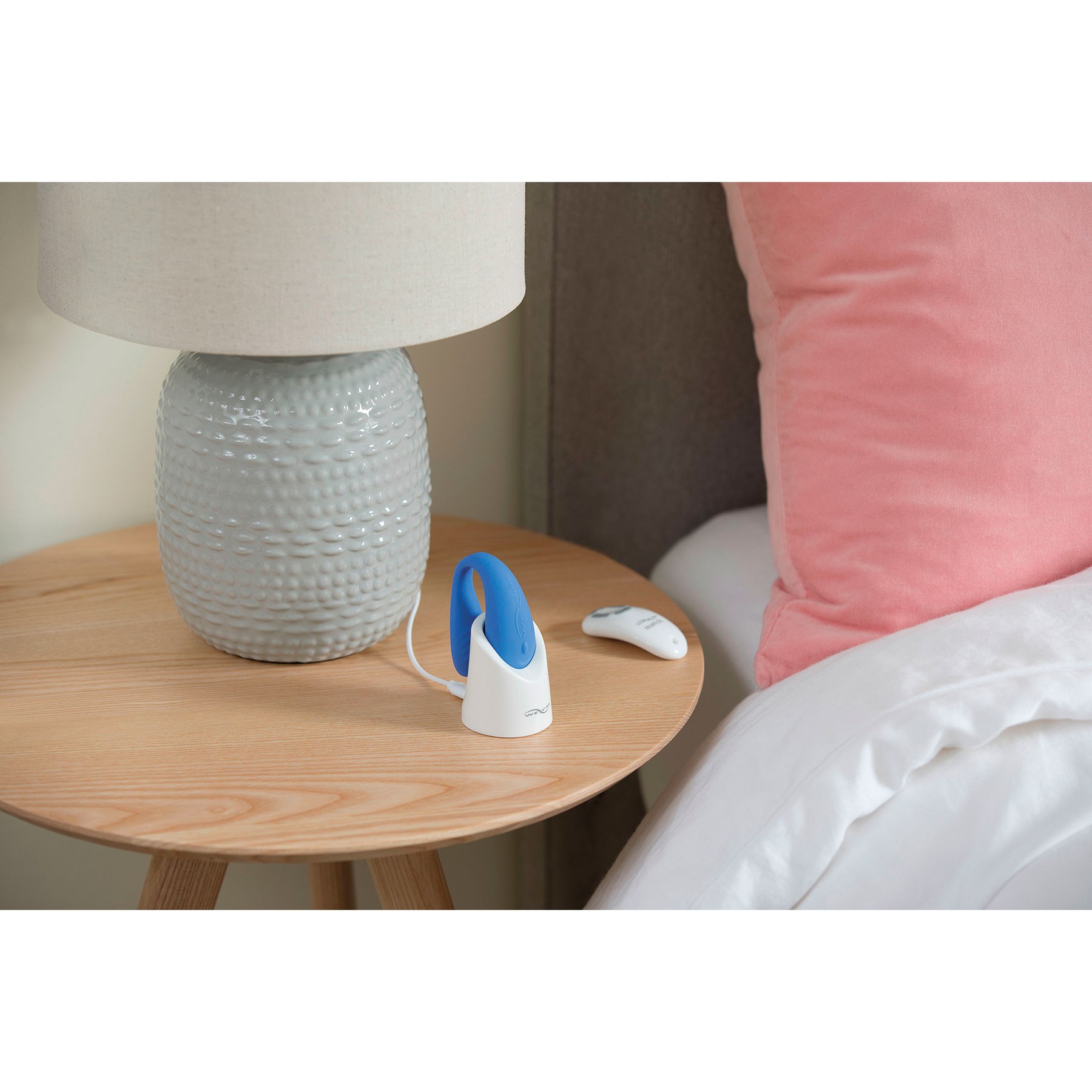 We-Vibe Match Couples Massager displaying on table
