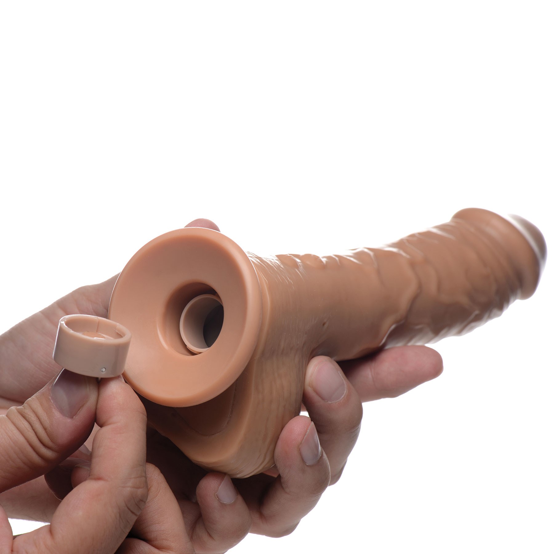 Loadz Vibrating Squirting Dildo brown version with hand removing cap from end to fill with liquid