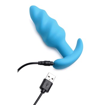 21X vibrating silicone swirl butt plug with USB cable inserted into charging port