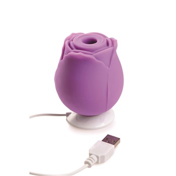 Gossip Come Into Bloom Rose Clitoral Stimulator - Showing Product Placed in Charging Station-Purple
