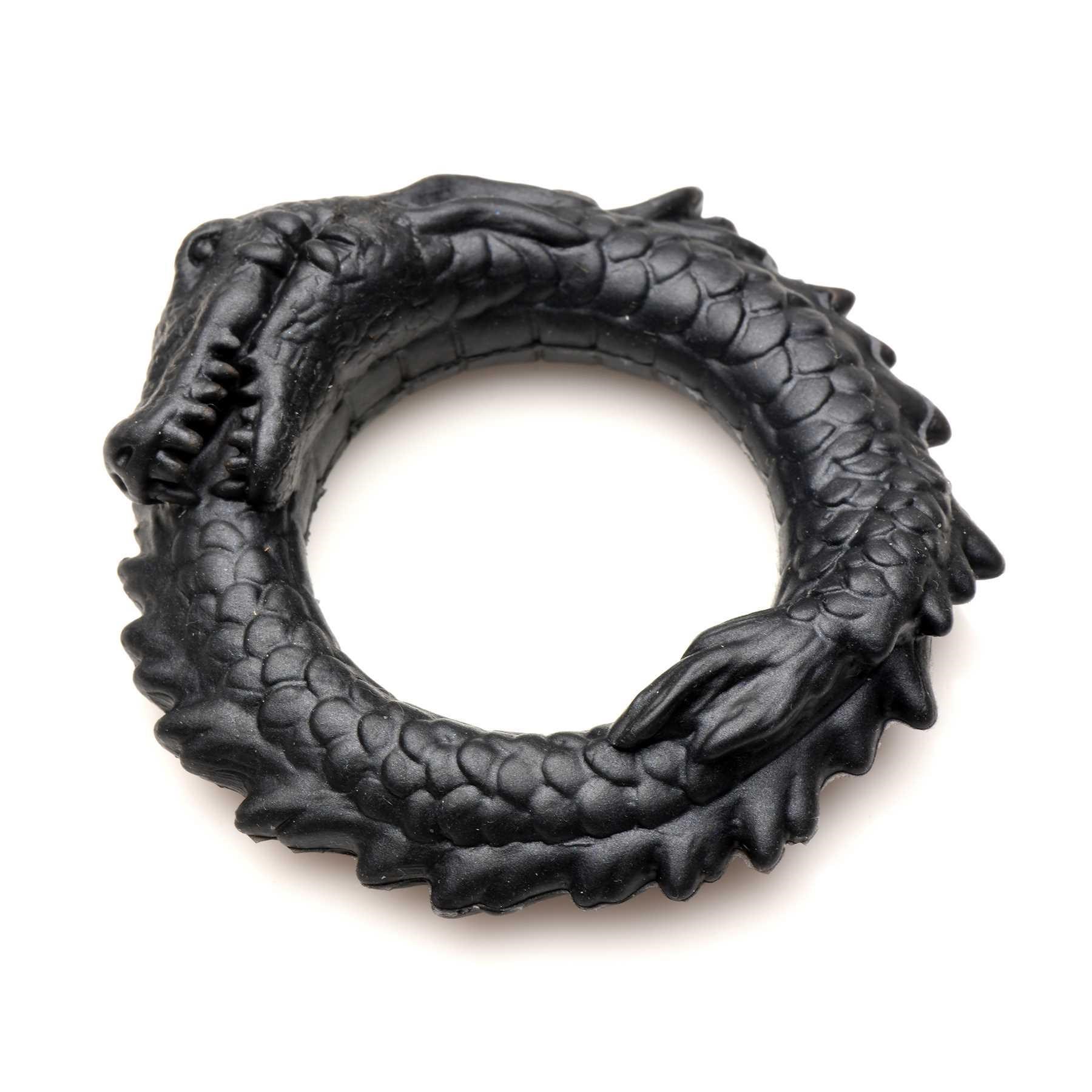 Creature Cocks Black Caiman Silicone Cock Ring laying flat on table