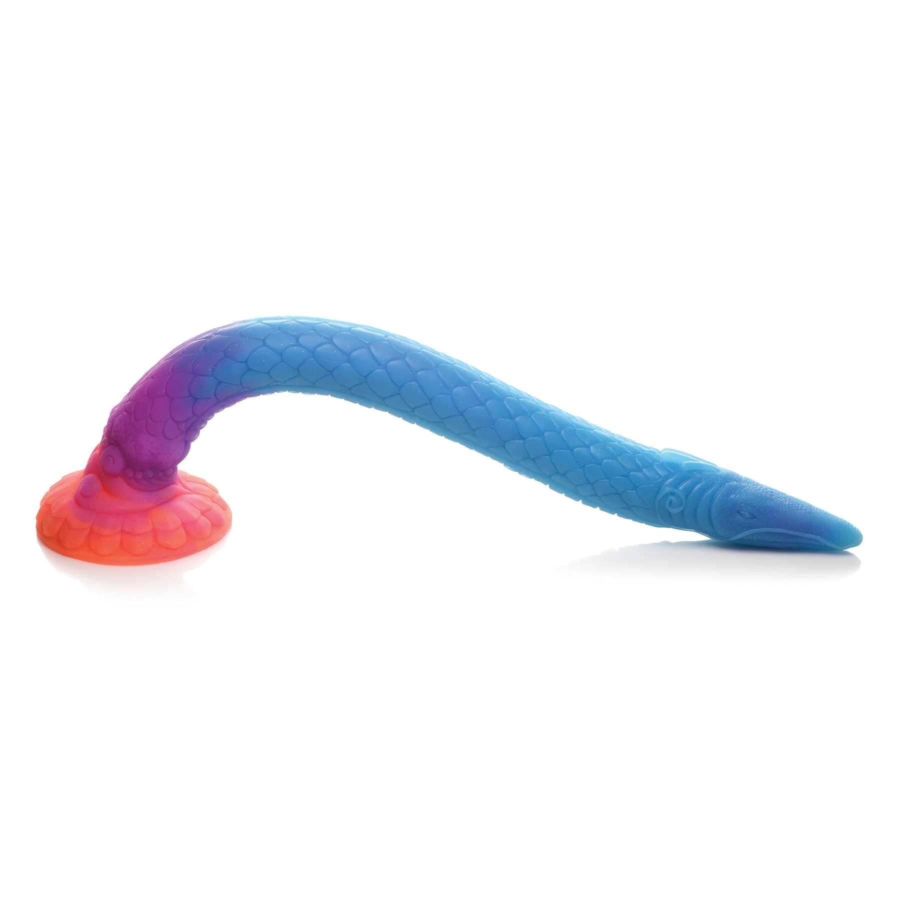 Mikara - Glow-in-the-Dark Silicone Snake Dildo suction cupped to table top