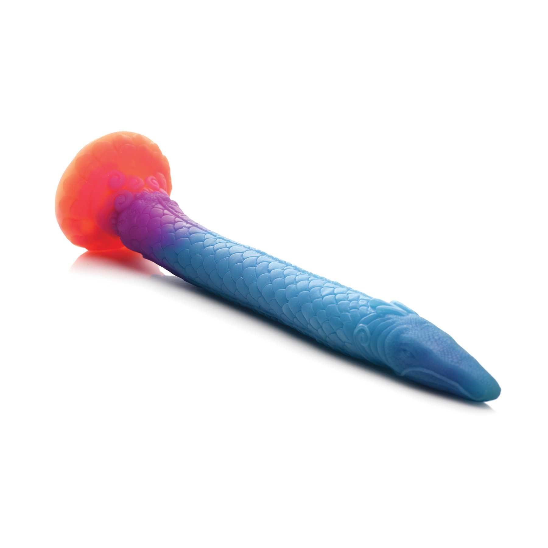 Mikara - Glow-in-the-Dark Silicone Snake Dildo laying on a table