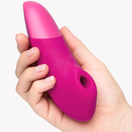 Womanizer Enhance Pleasure Air Clitoral Stimulator pink in hand