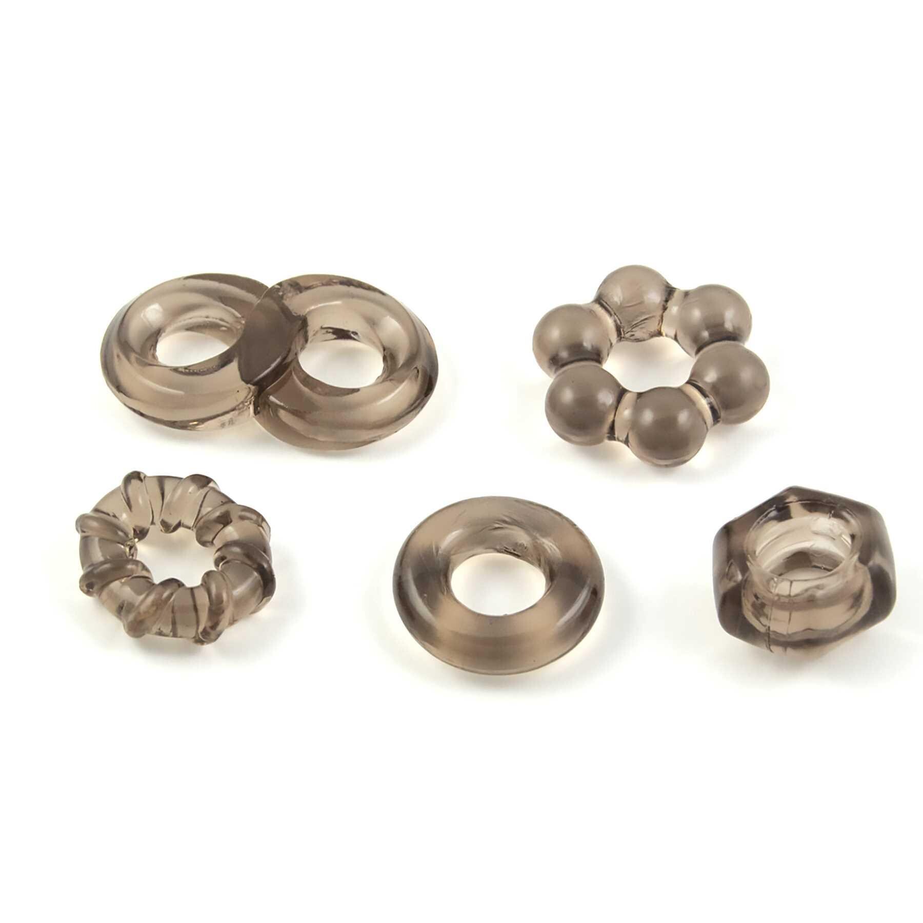 ENHANCER FIVE PIECE COCK RING SET-BLACK laying on table